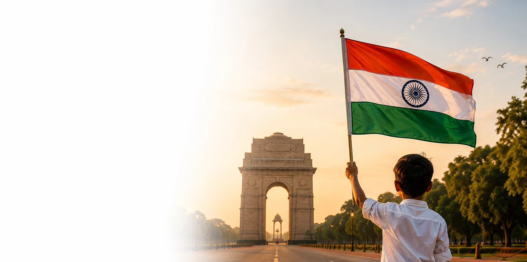 A boy holding the Indian national flag near India Gate at sunrise